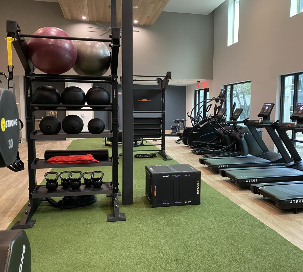 a fitness center with a strip of turf installed in the middle