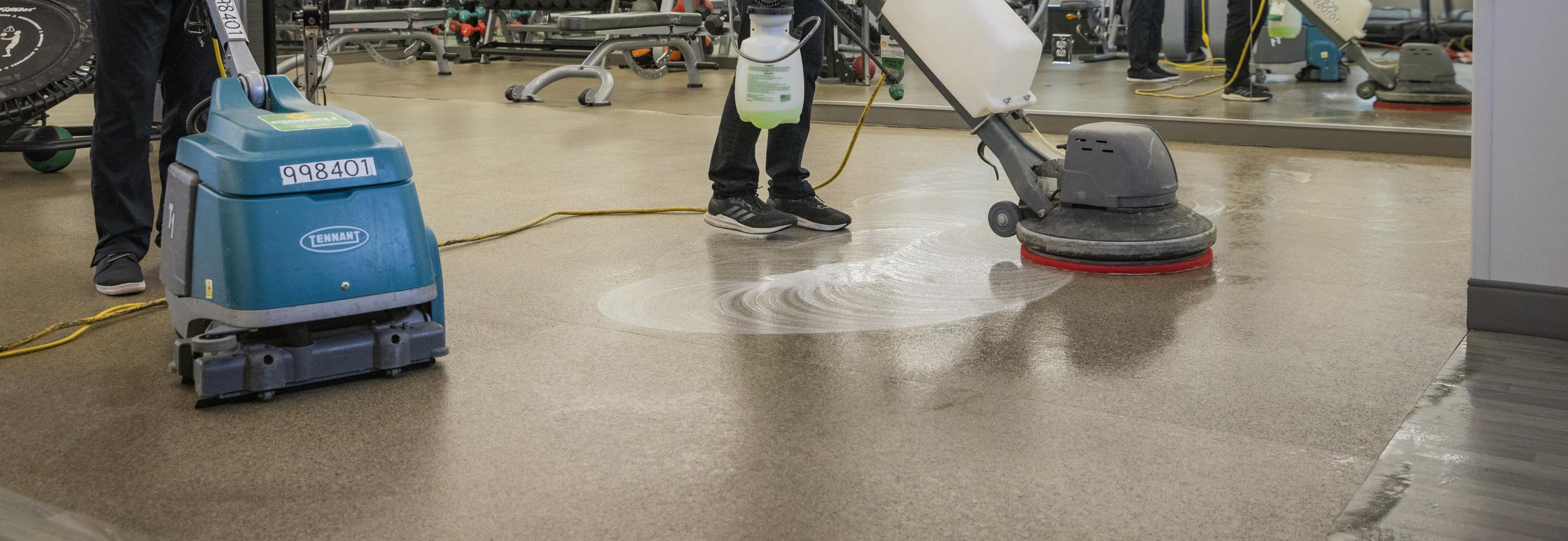 Person cleaning a floor using the proper cleaning supplies