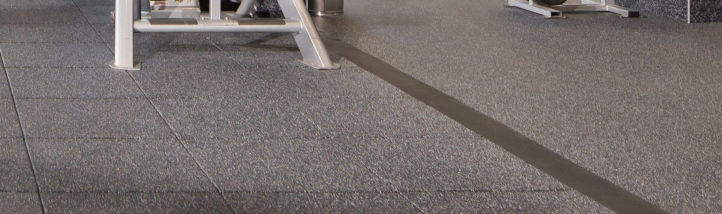 A close up shot of a gym floor with a Reducer being used to level the floor