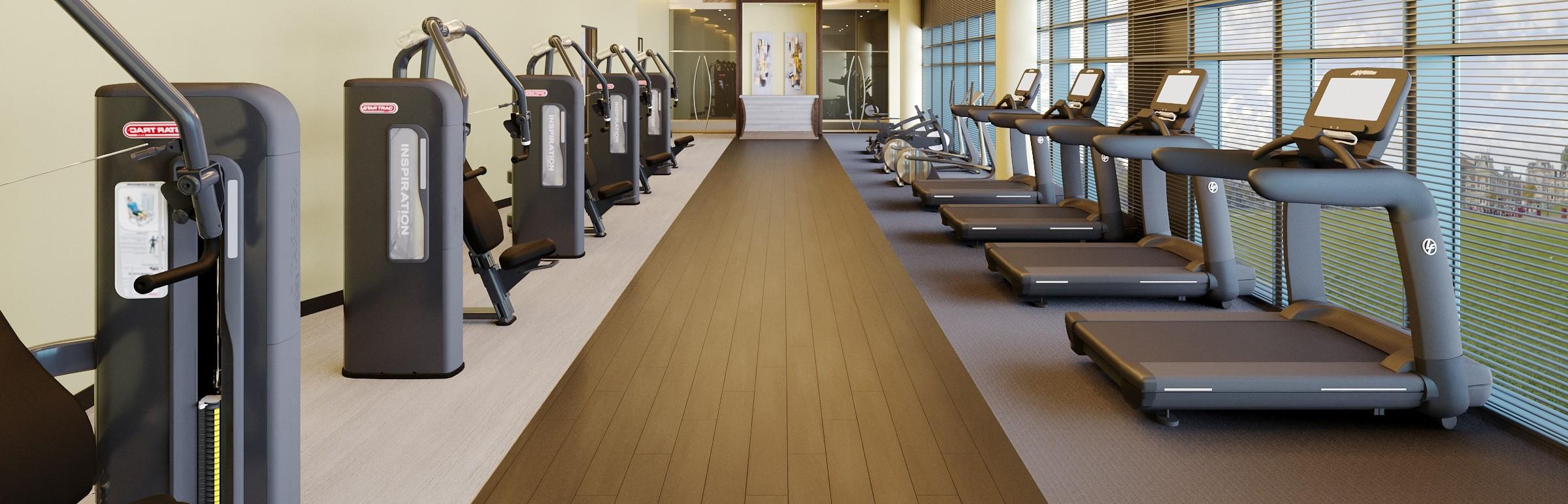 A fitness room with gym equipment on both sides of the room