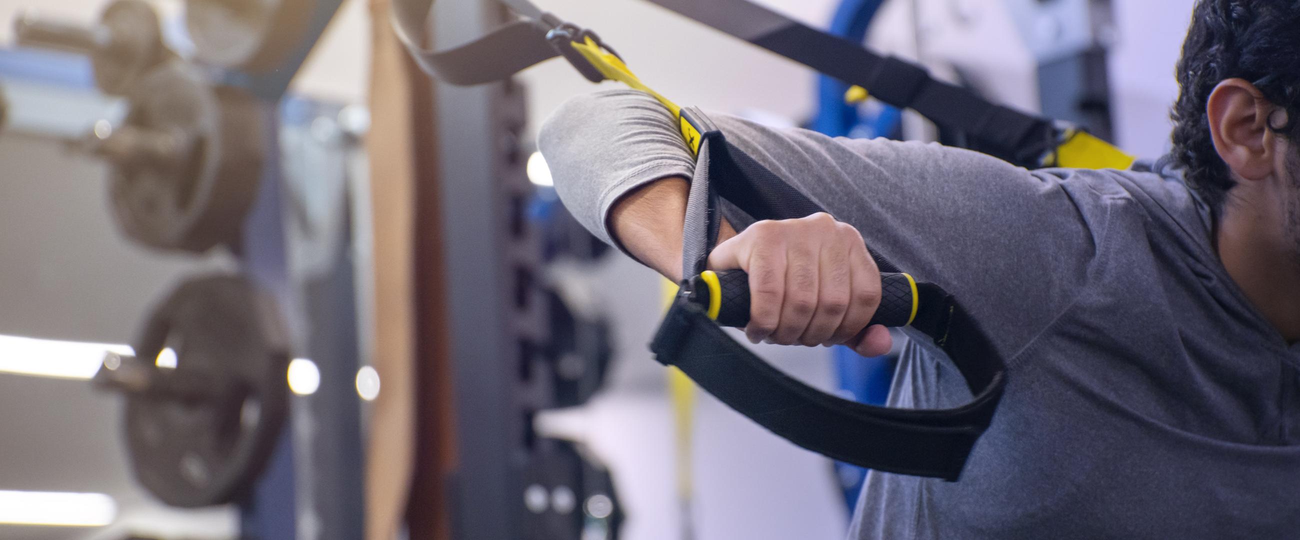 A man doing a pec fly on a selectorized strength machine