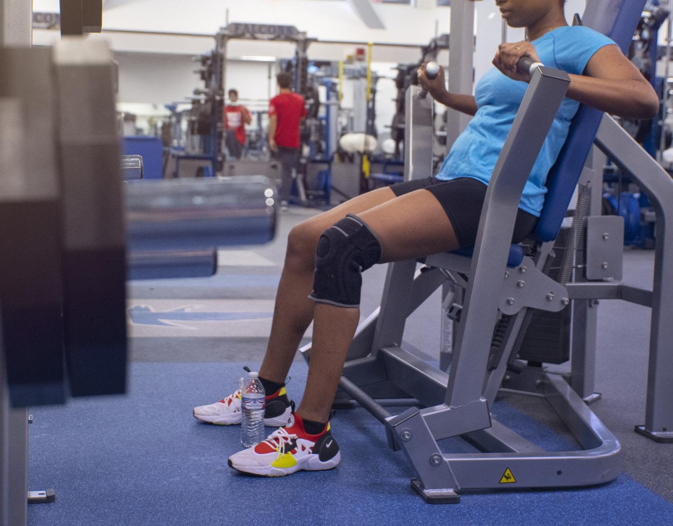  A woman working out in a gym with Performance flooring