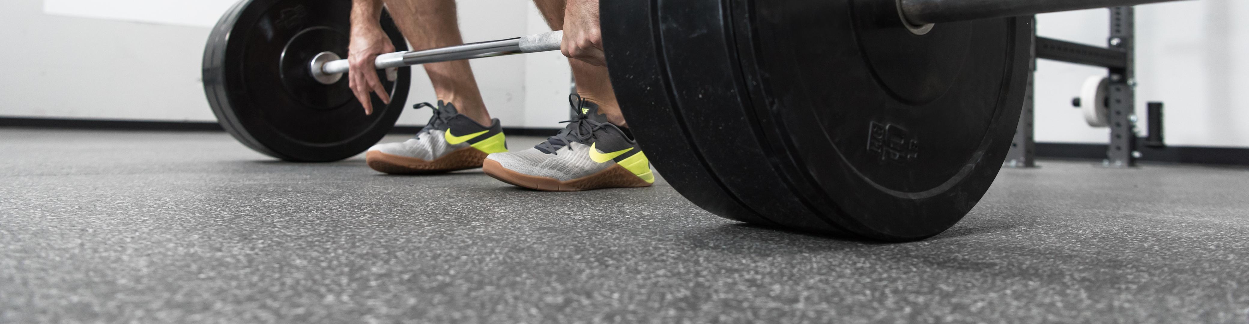 A man in the middle of a deadlift on a Performance Modzilla flooring