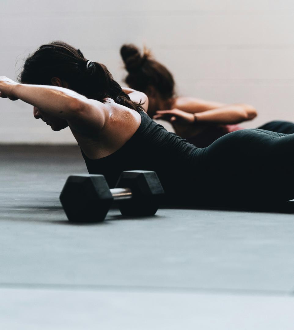 A woman doing a push up on a ComPact-Marble flooring.