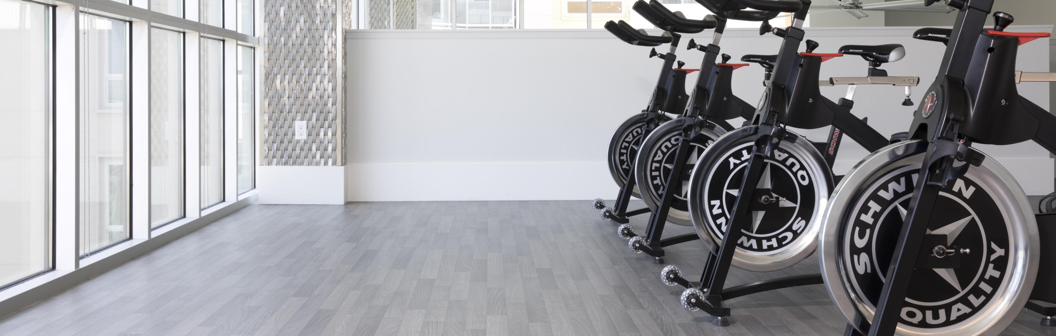A line of spin bikes in a studio on Ecore Athletic flooring