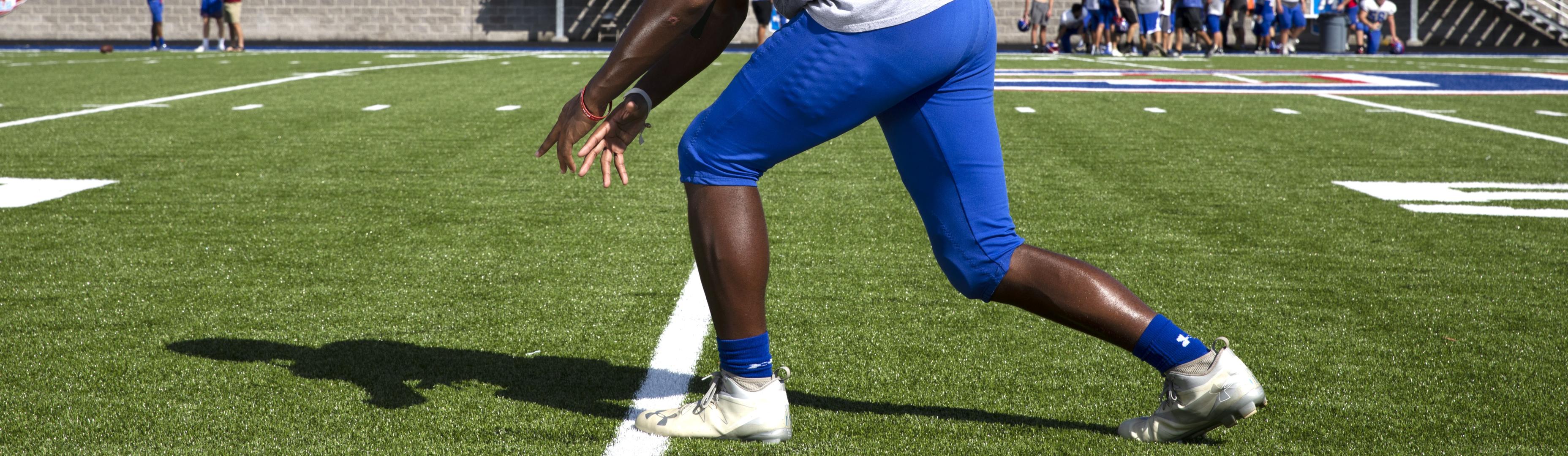 A football player on a turf field