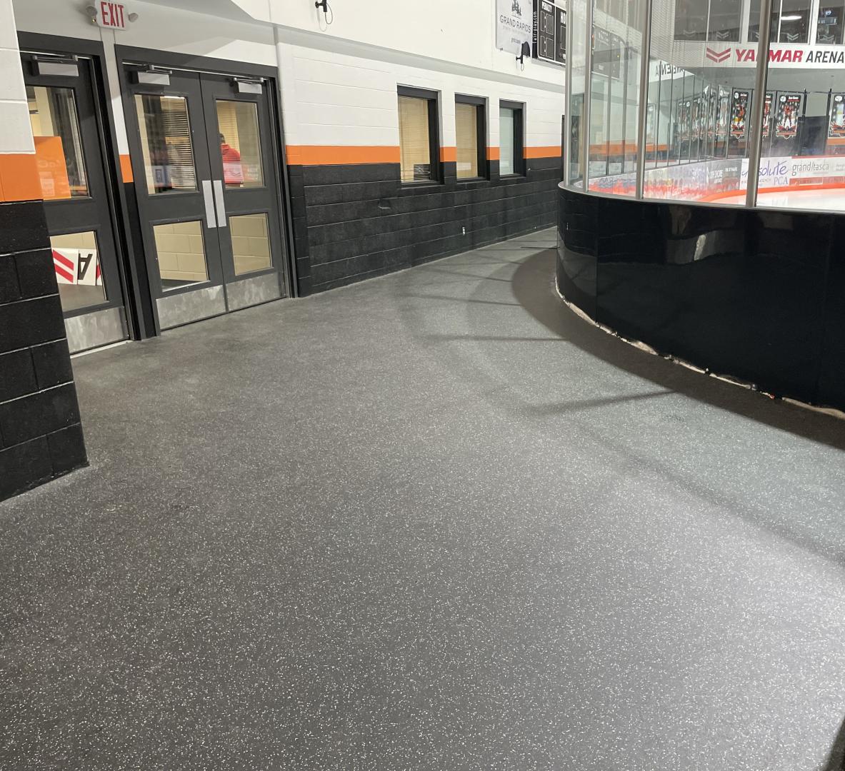 A side of an ice skating rink with Ecore Athletic flooring