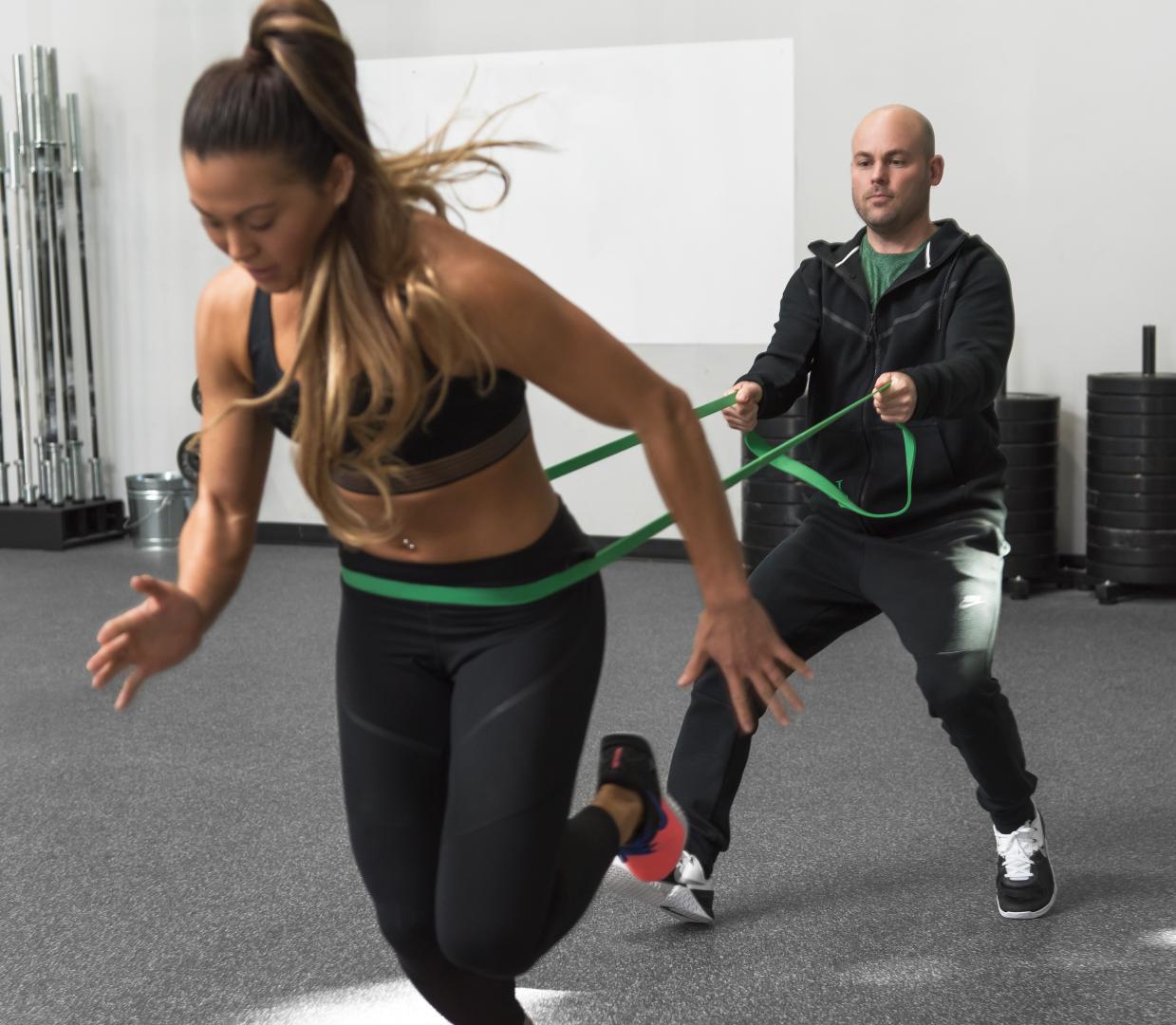 two people working out by using resistance bands