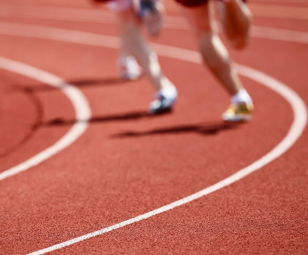 two runners running on a track
