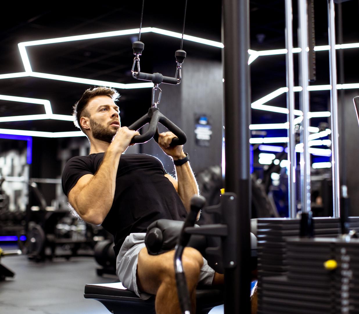 A man engages in strength training using a cable machine