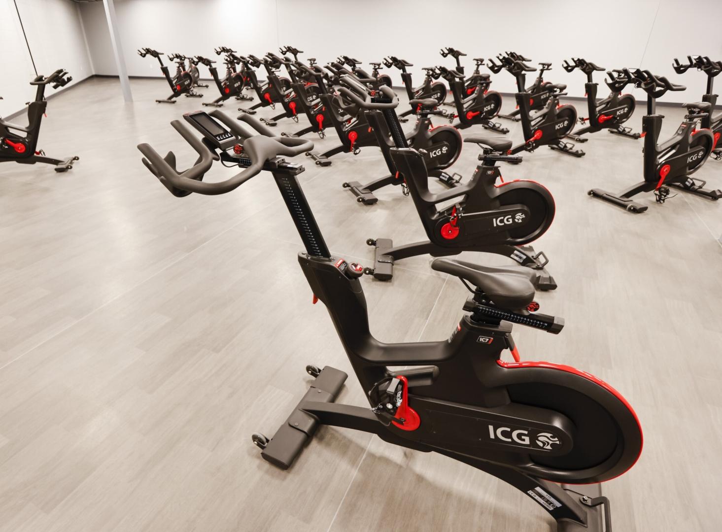 A group of spin bikes in a spin studio