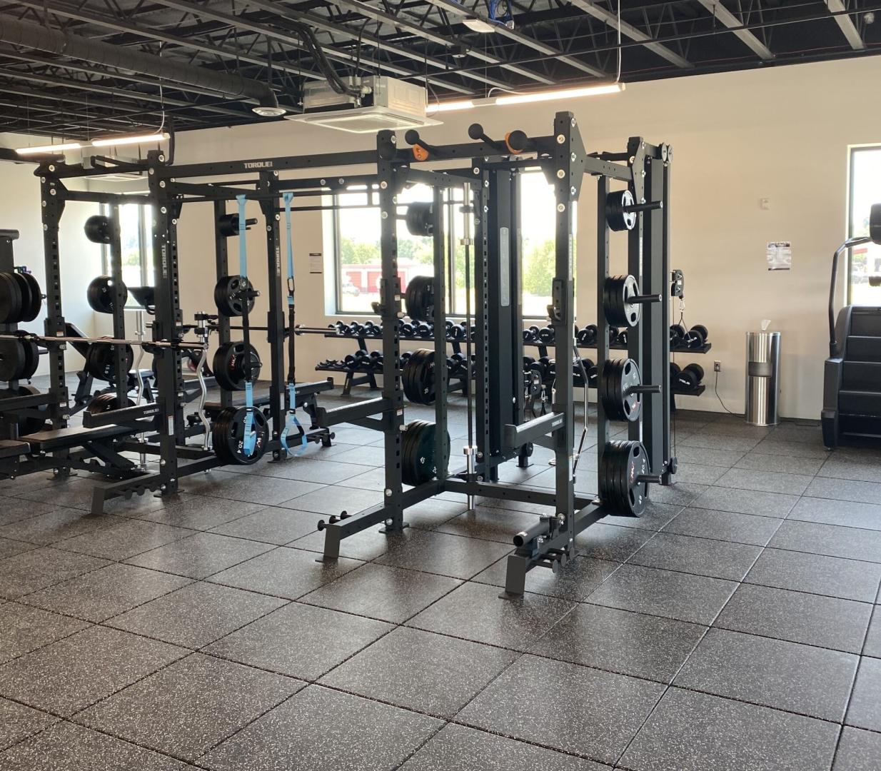 A fitness center with different equipment all on top of Performance UltraTile